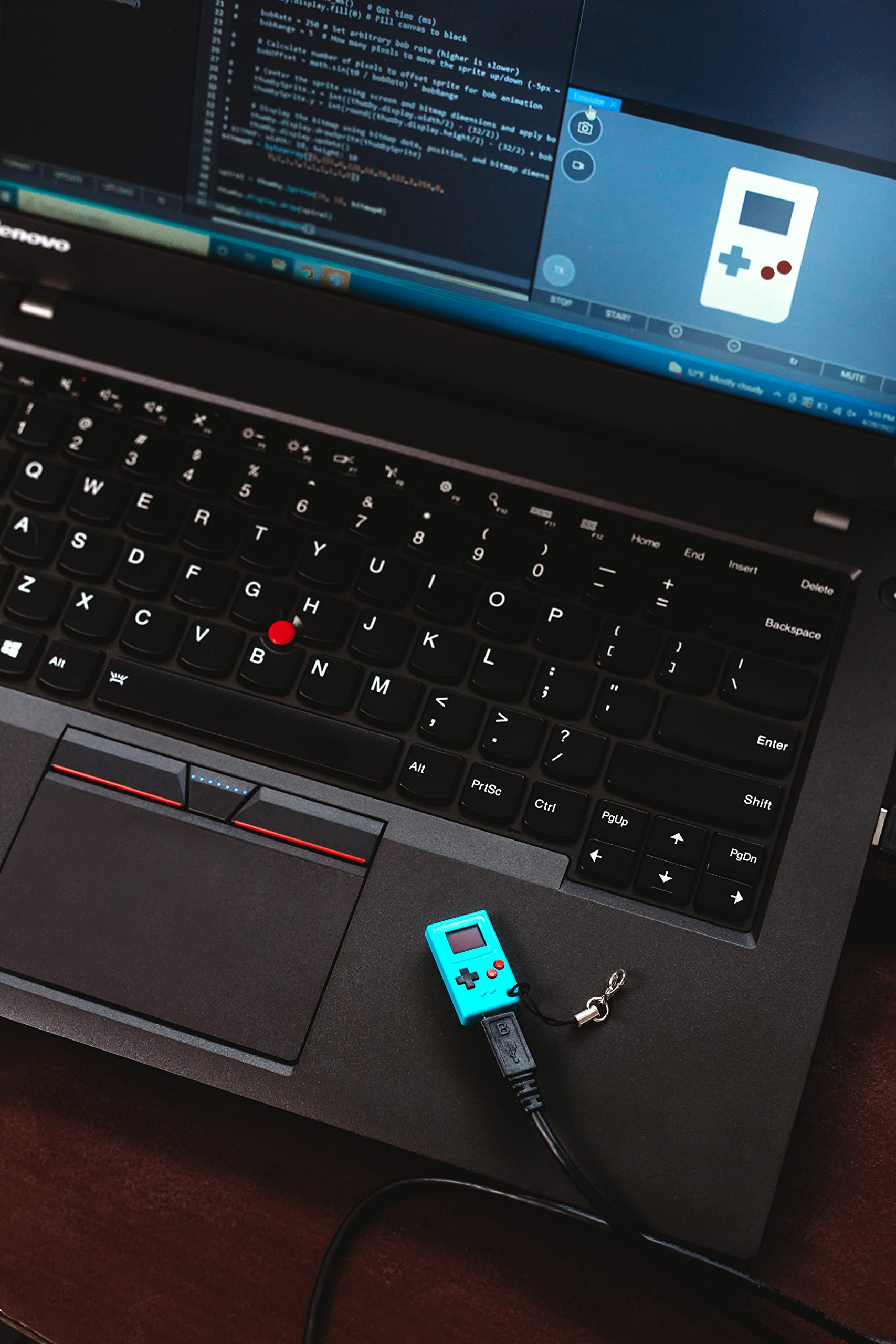 Small programmable STEM learning toy keychain attached to a set of house keys