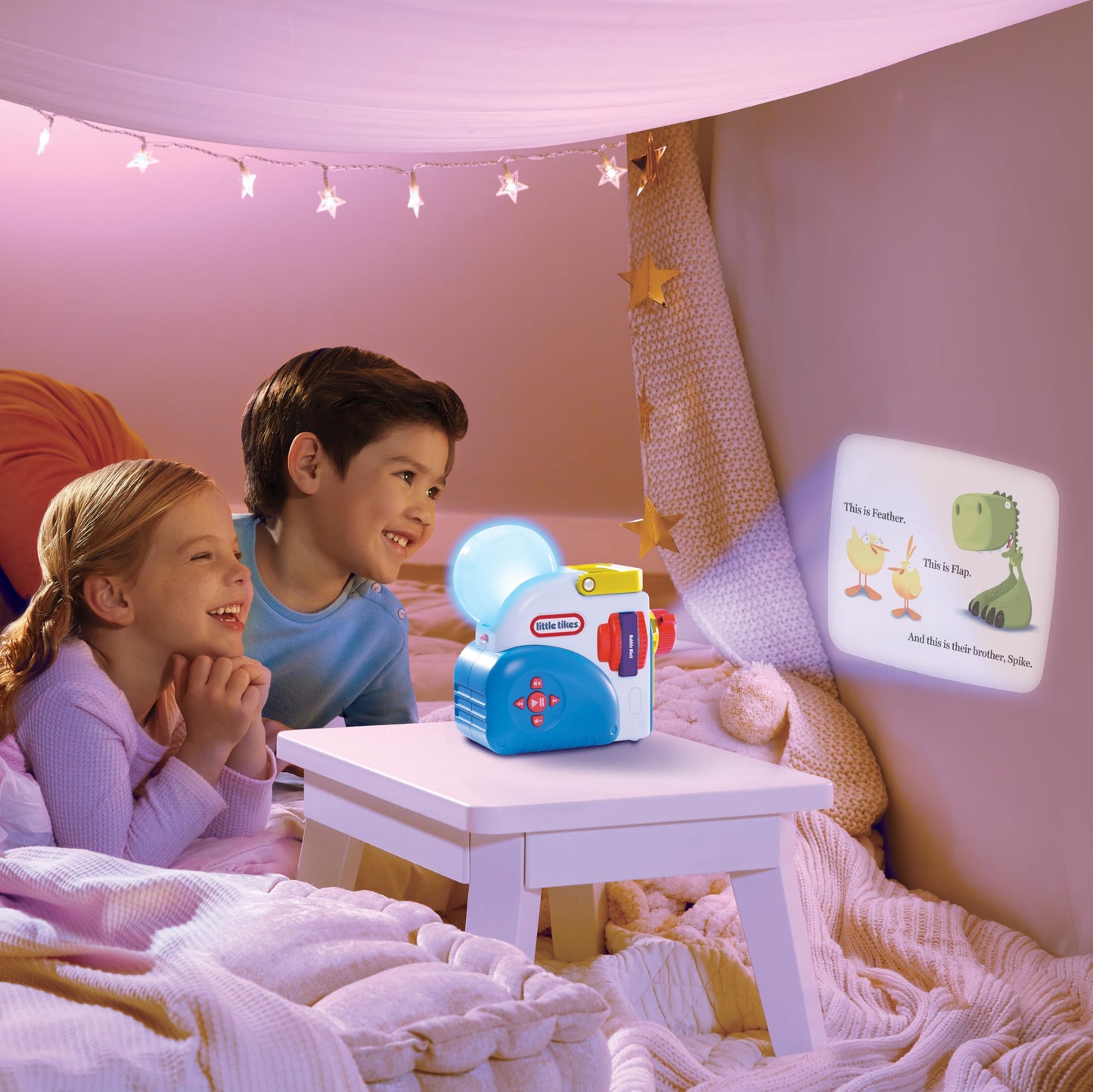 Spike the dinosaur character figure from Little Tikes standing next to three interactive story reels.