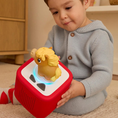 Tonies child friendly screen free audio system with squeezable cow horse and pig characters.
