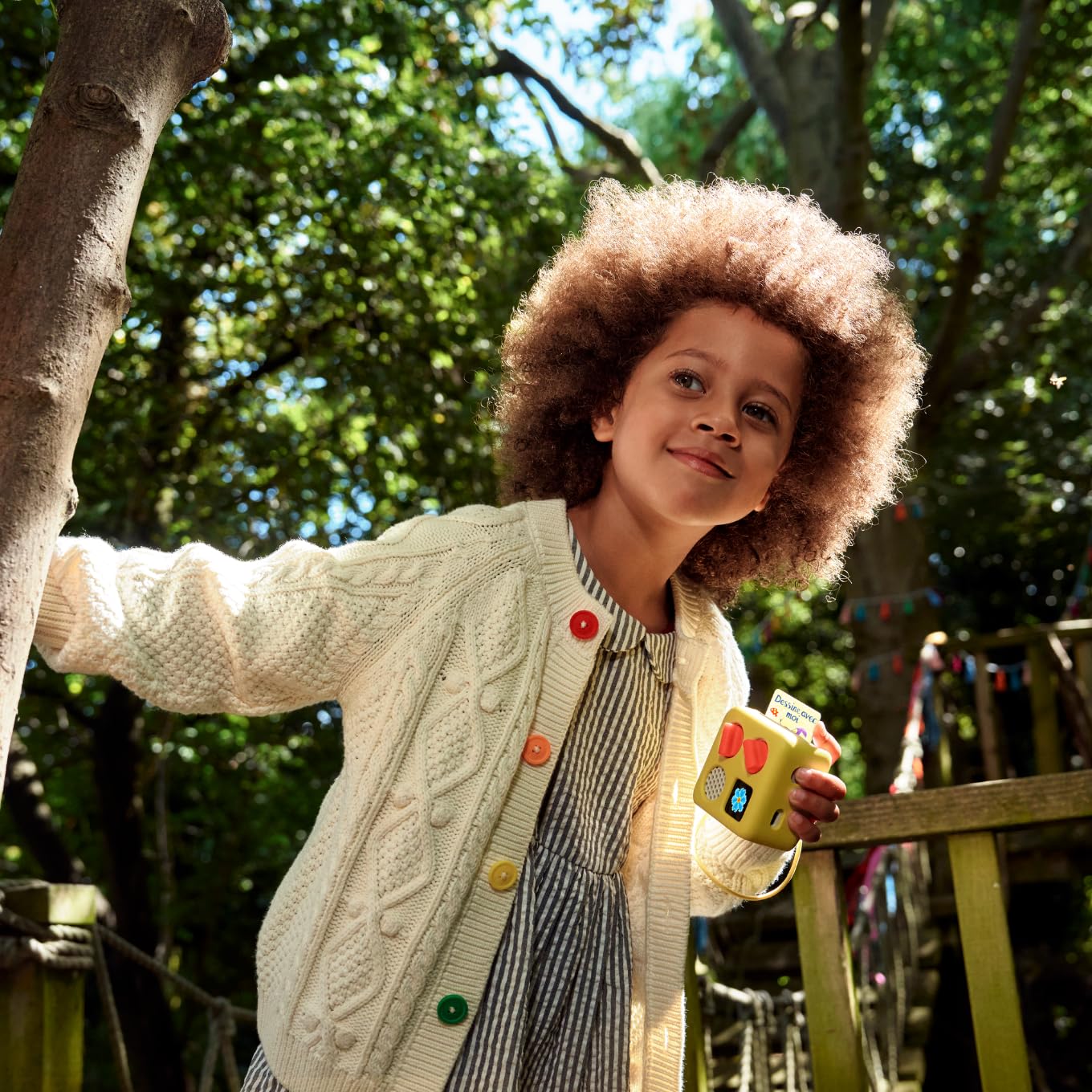 Child holding the safe screen free educational audio accessory ready for playtime use.