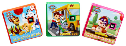 Toddler using the Little Tikes interactive storytelling machine to project PAW Patrol book pages onto a bedroom wall.