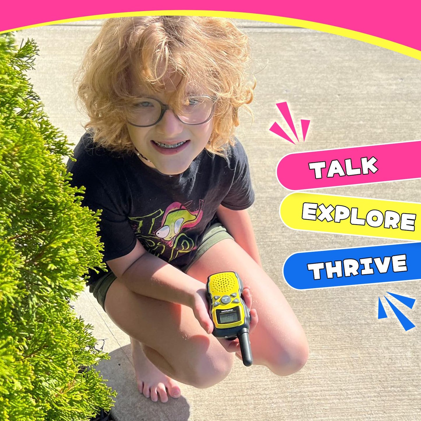 Children playing outdoors with pink and purple walkie talkies