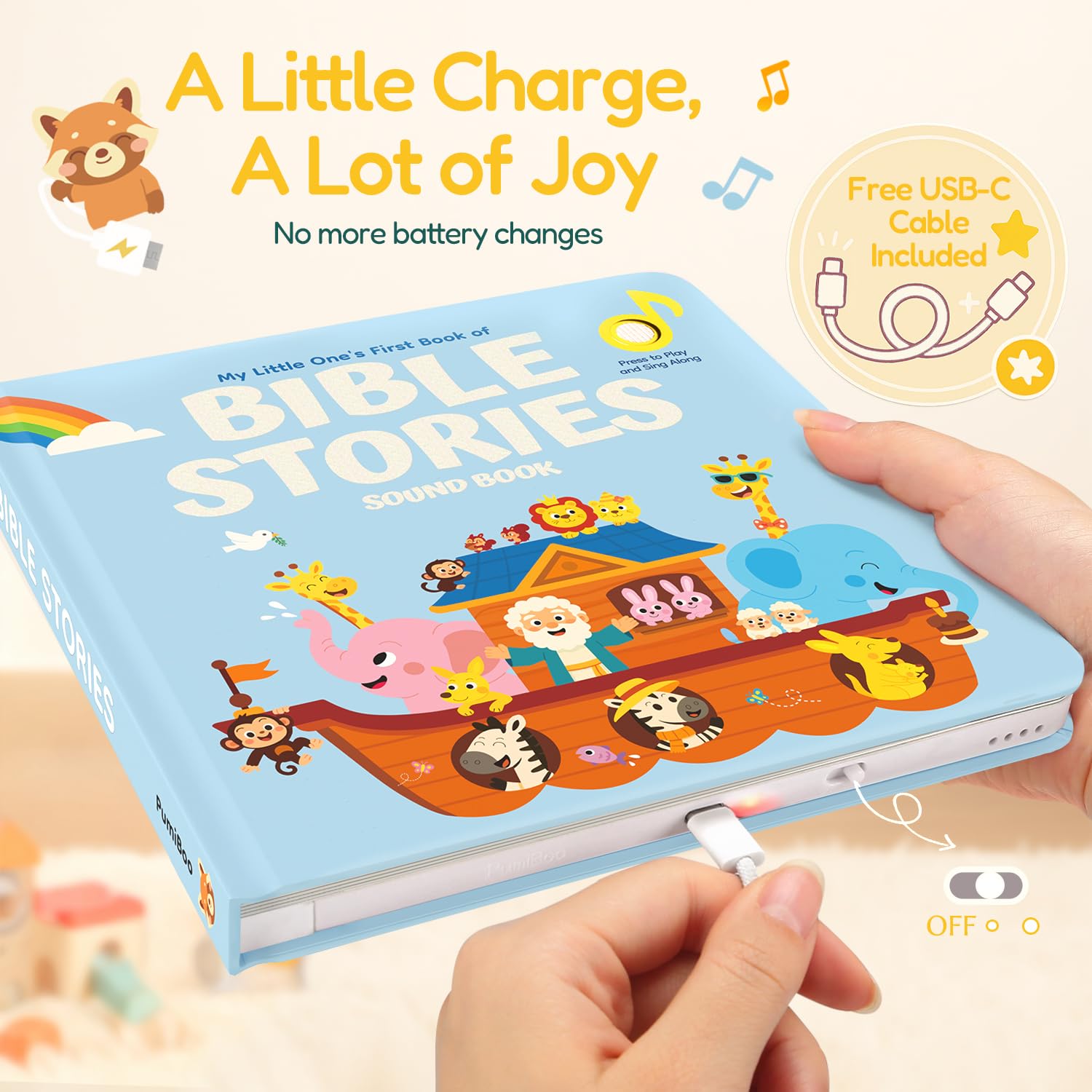 Child hands playing with Pumiboo Bible songs board book