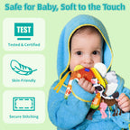 Infant playing with crinkle fabric book pages