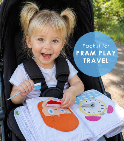 Toddler playing with felt pieces in fabric busy book
