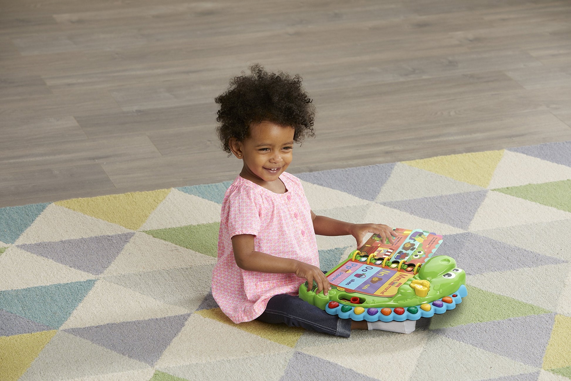 Toddler playing with LeapFrog Dino's Delightful Day book interactive buttons