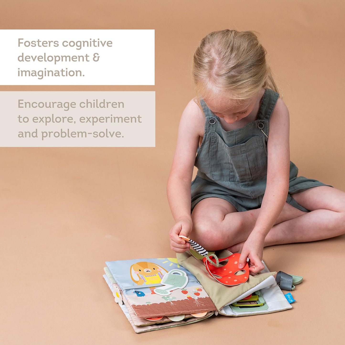 Taf Toys Montessori activity book spread open to show multiple features