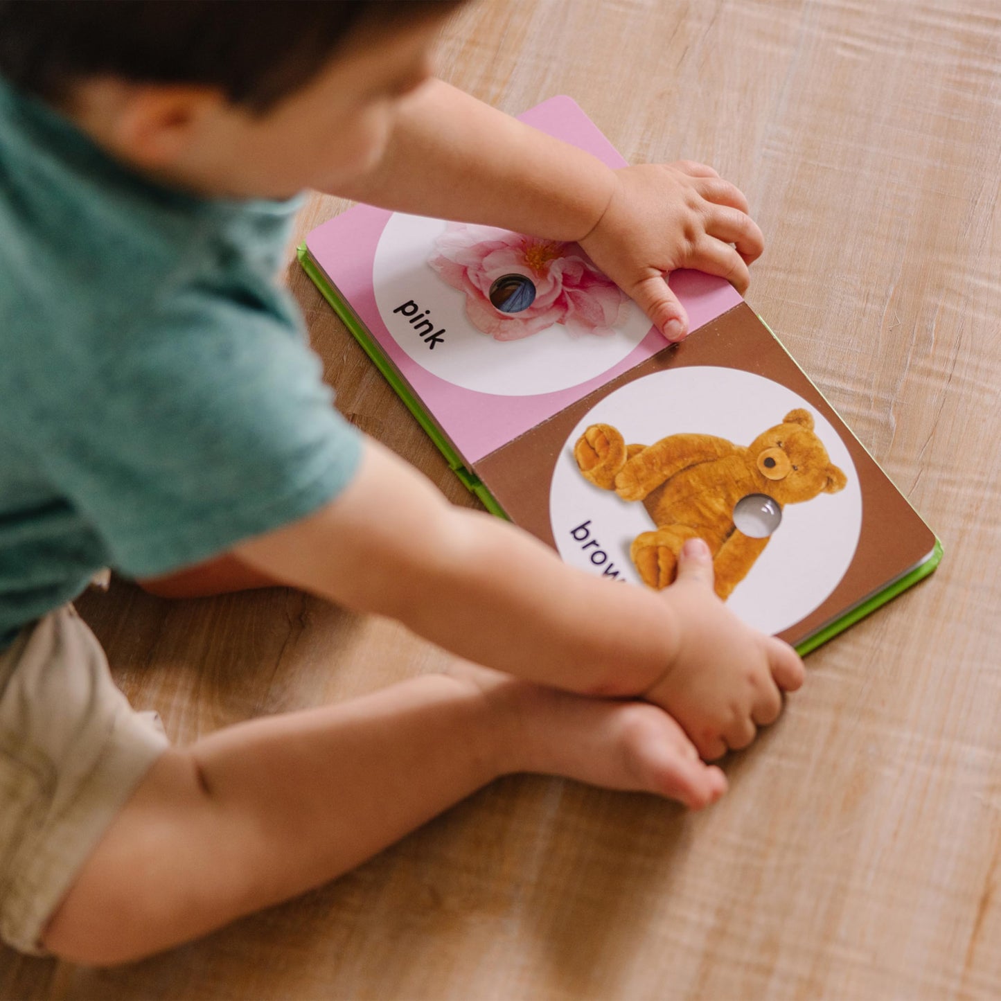 Toddler hands interacting with Melissa and Doug sensory books