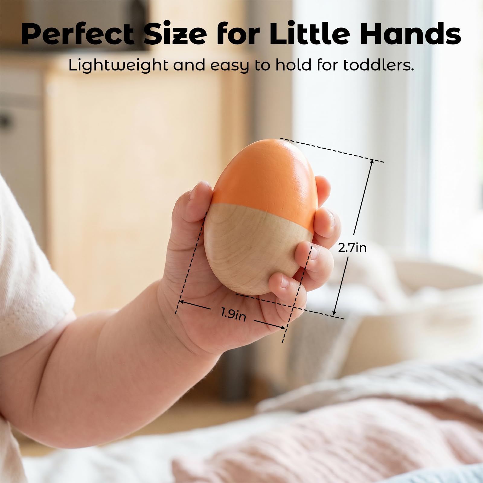 Toddler hand holding a green and yellow striped premium wood musical percussion egg rattle
