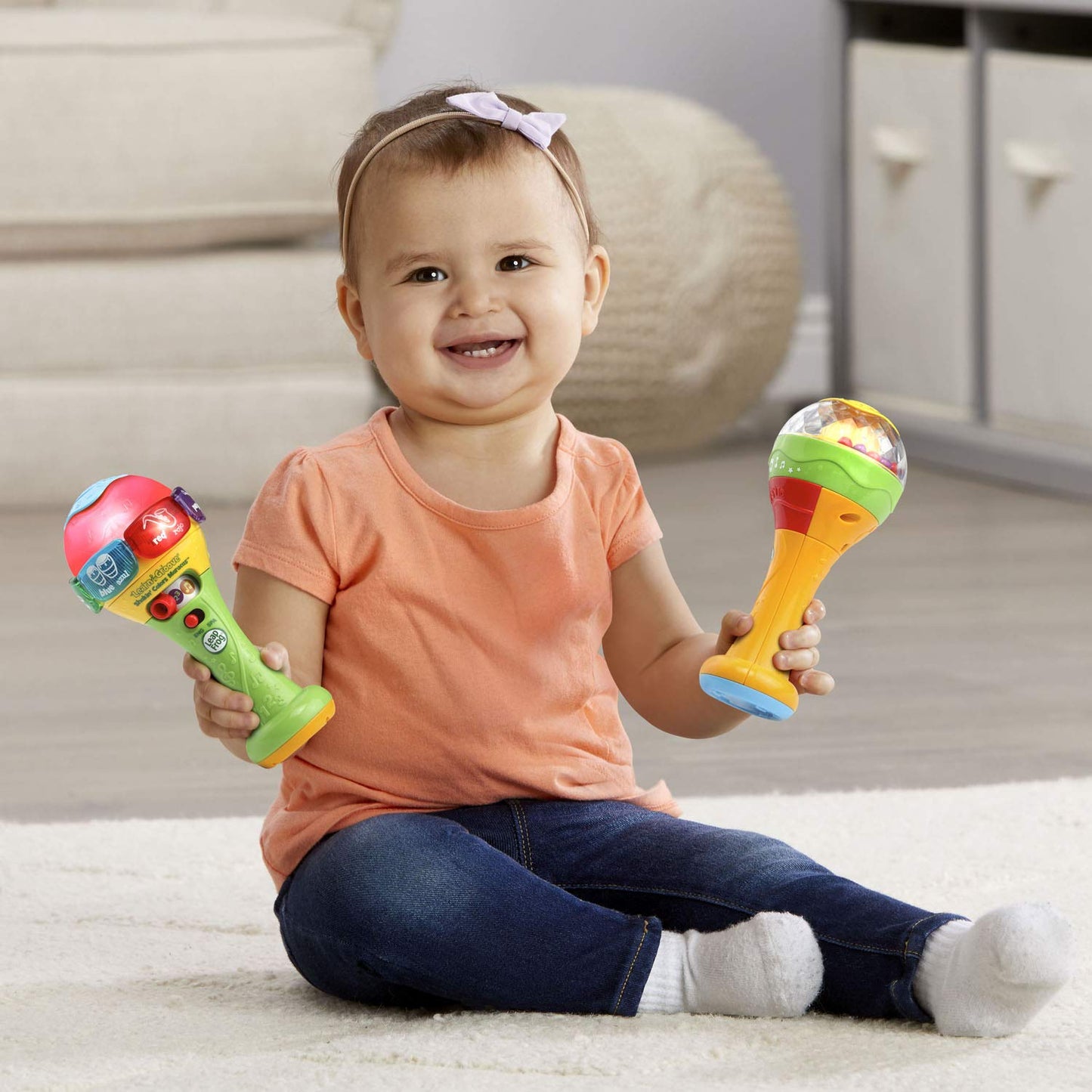 LeapFrog manual shaker maraca filled with multi-colored plastic rattling beads for sensory play.