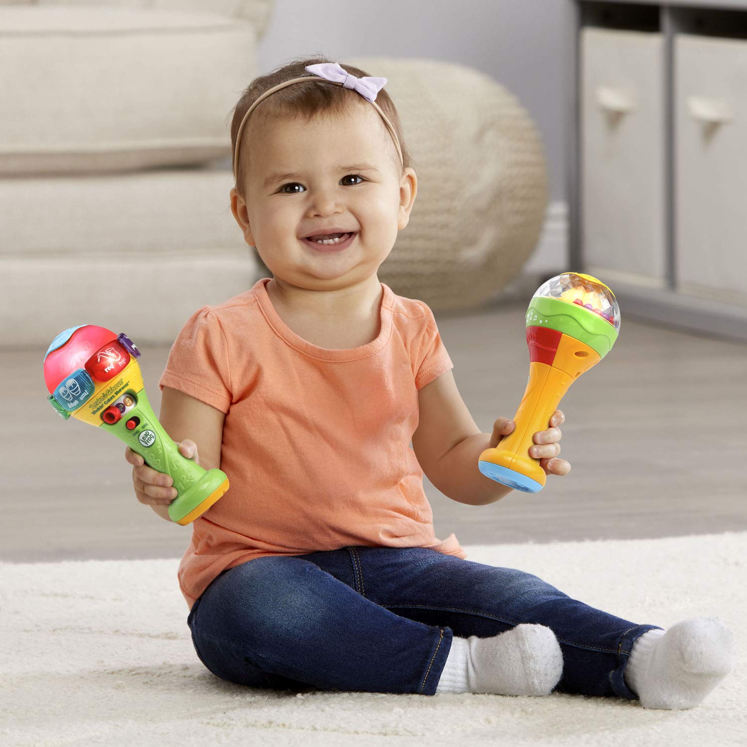 LeapFrog manual shaker maraca filled with multi-colored plastic rattling beads for sensory play.