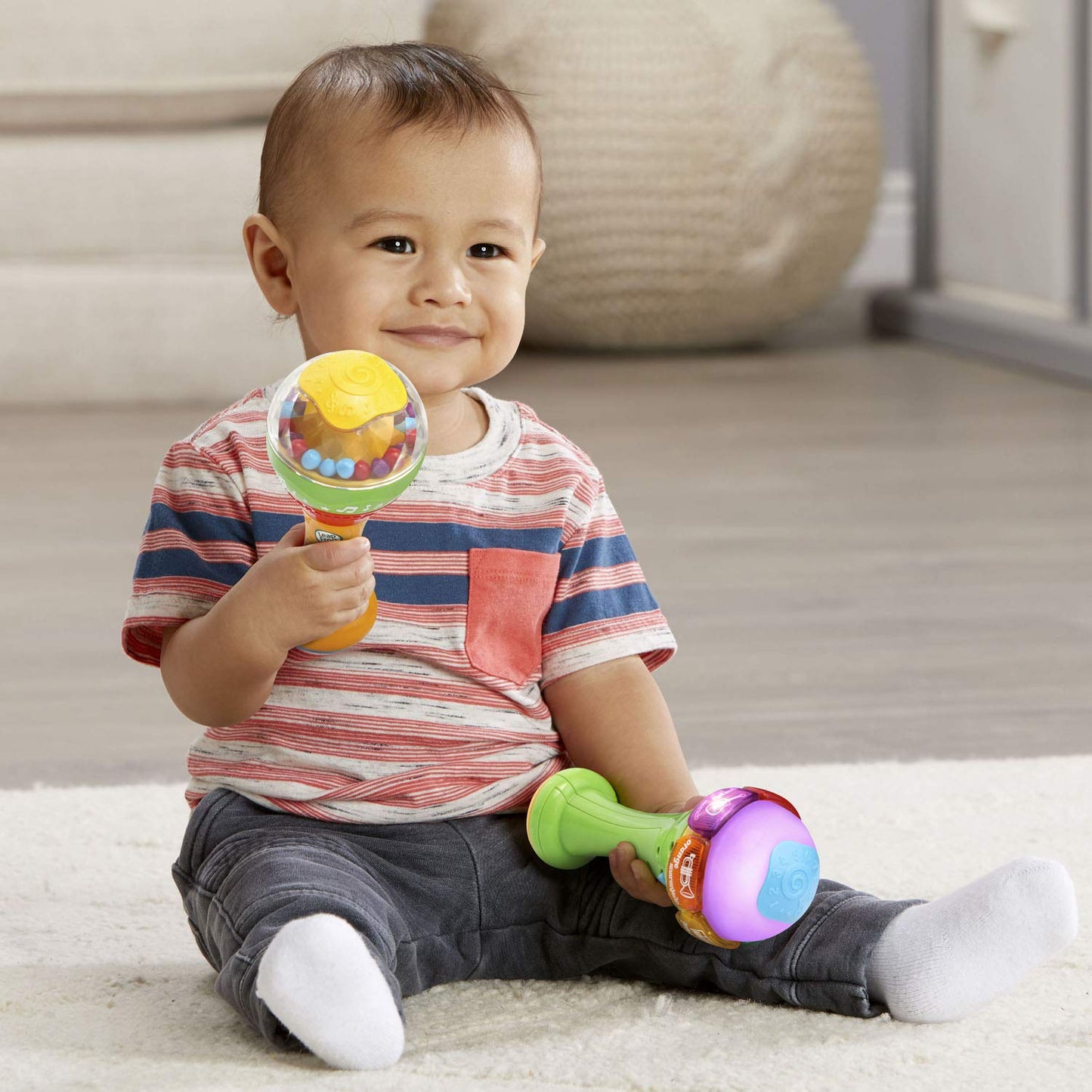 Side view of LeapFrog bilingual learning maracas showcasing the ergonomic handle grip for infants.