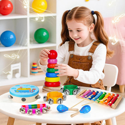 Toddler hand shaking the childom red and blue wooden maracas showing the easy to grip design for early childhood development