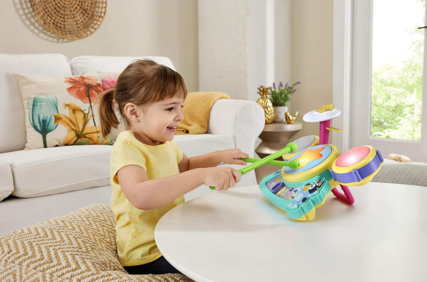 Close up view of the Bluey character button and built-in speakers on the learning toy