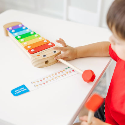 Melissa & Doug wooden musical toy with self storing mallets placed as caterpillar antennae.