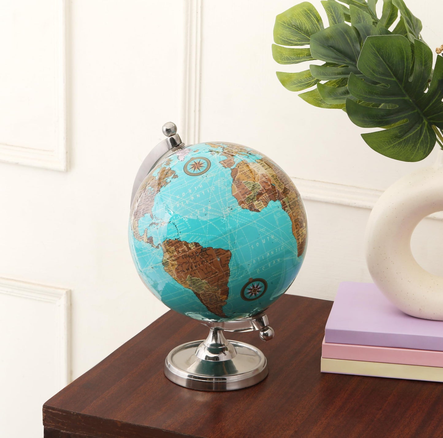 Rely+ globe displayed on a modern office bookshelf