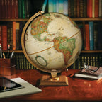 Replogle vintage style world globe showing the sturdy walnut finish hardwood base close up view.