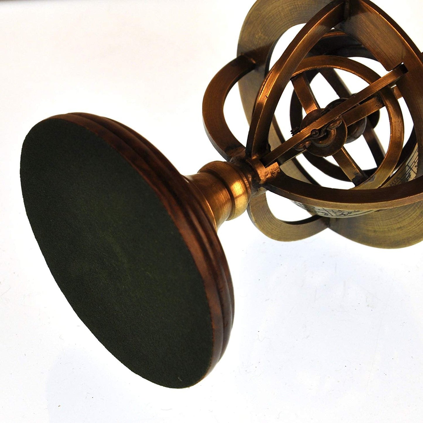 Detailed view of zodiac engravings on brass armillary sphere tabletop decor