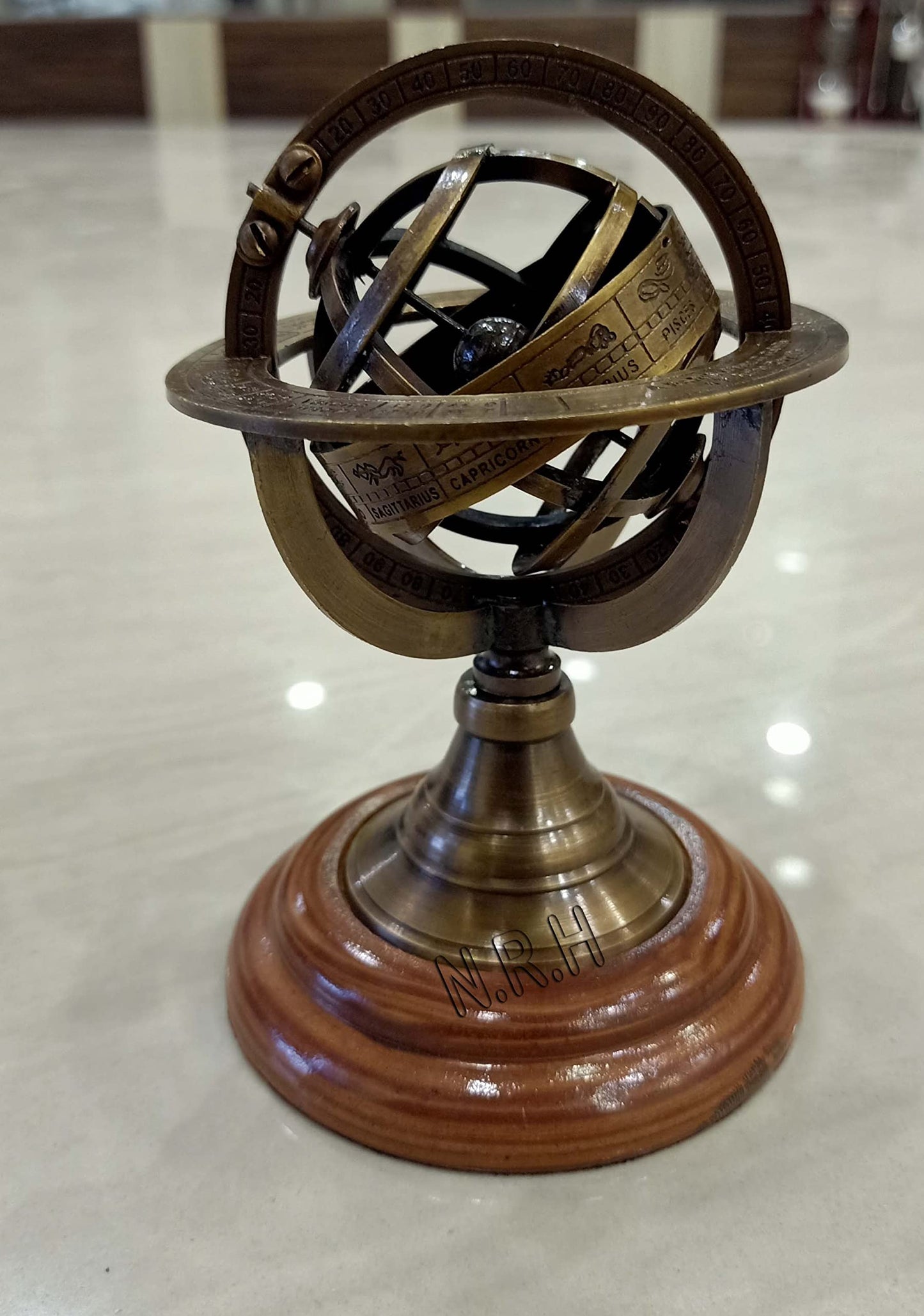 Close up of antique brass finish on planetary rings of armillary globe