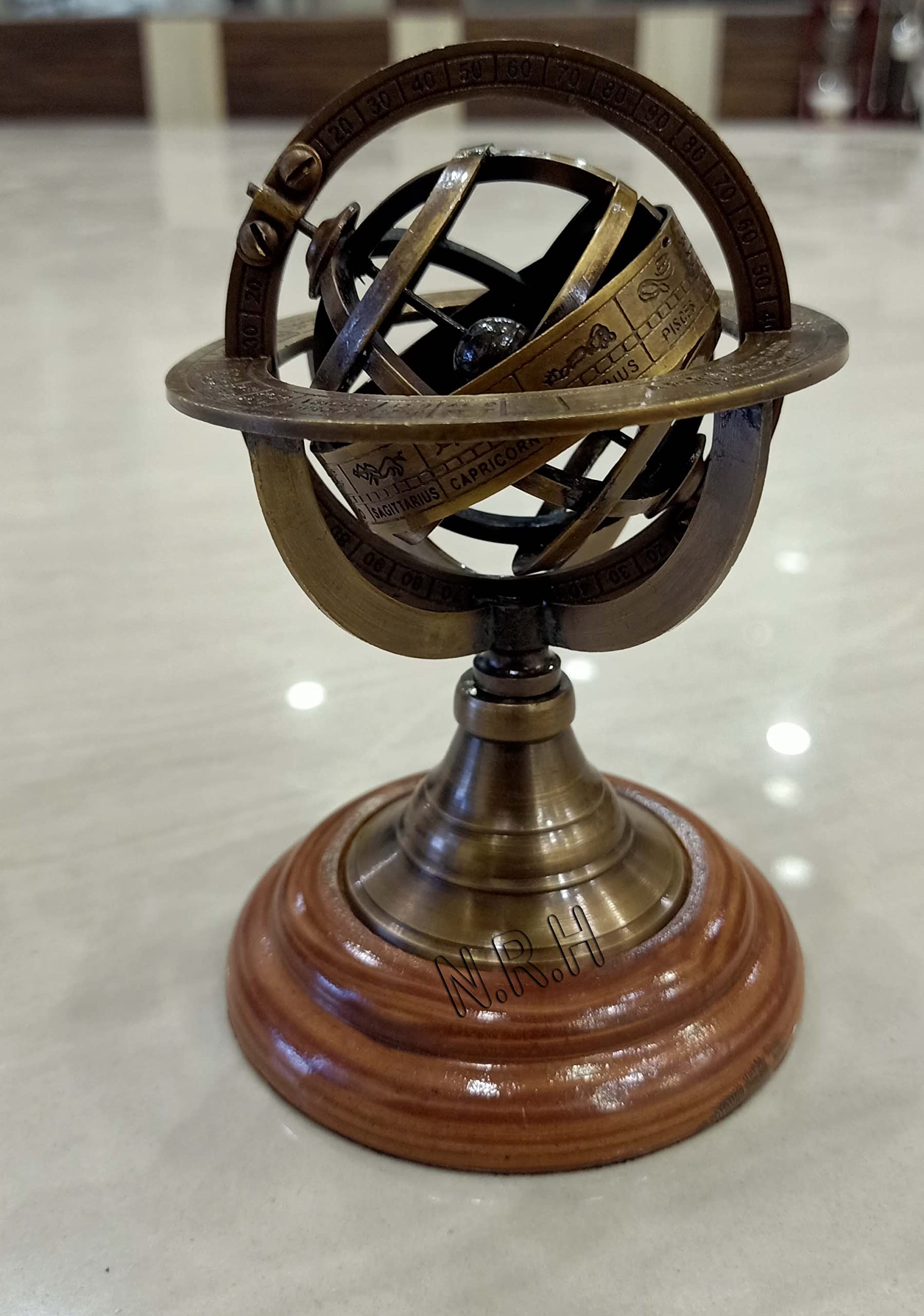Close up of antique brass finish on planetary rings of armillary globe