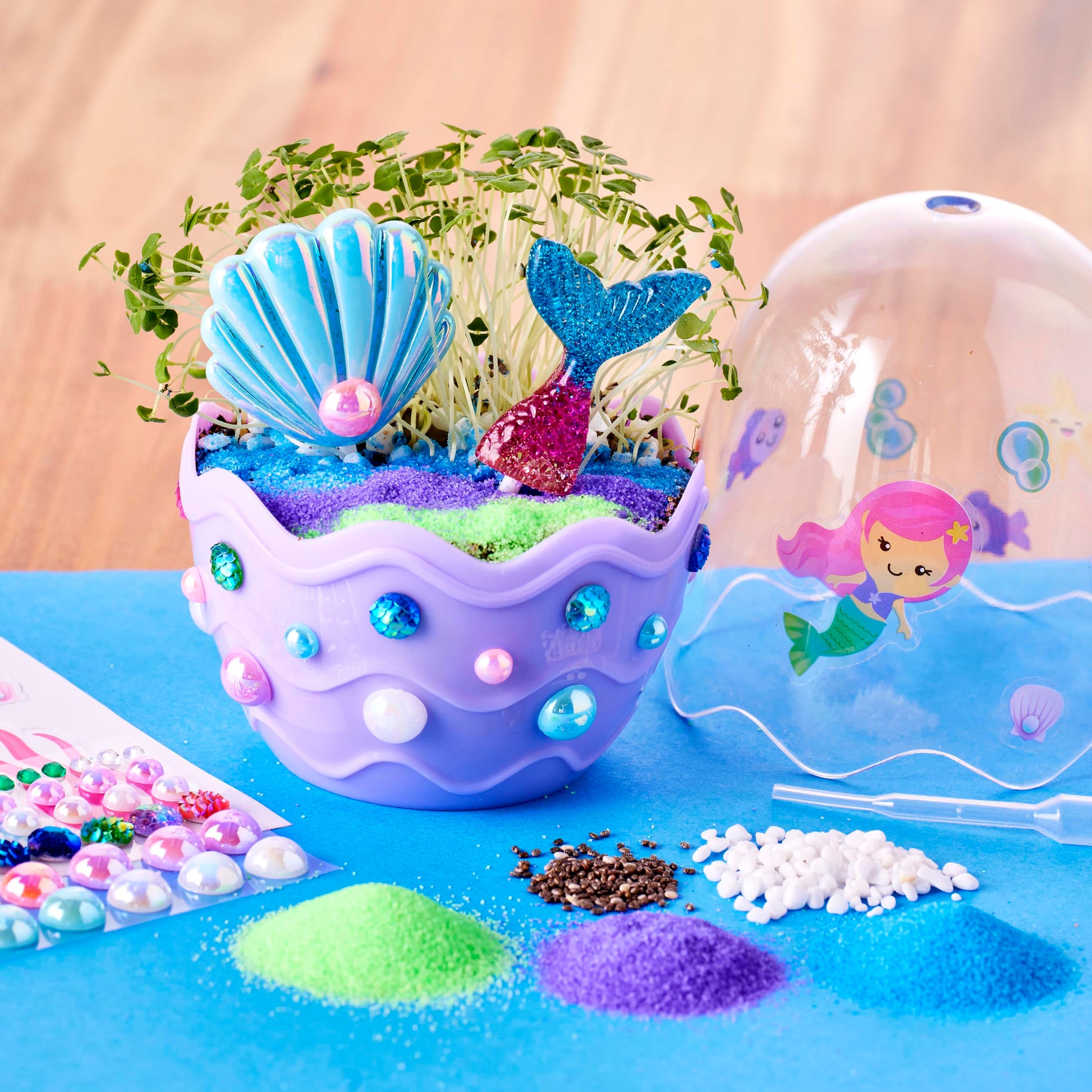 Side view of the compact ocean-themed mini terrarium showing layers of decorative gravel and sand
