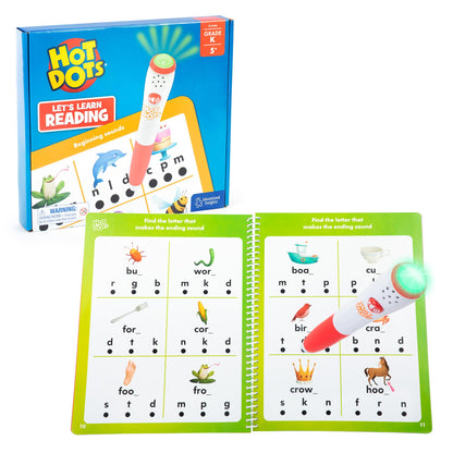 Child using the electronic talking pen on the black answer dots of the phonics activity workbook.