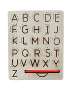 Toddler practicing pencil grip and alphabet formation using the wooden stylus on the grooved board