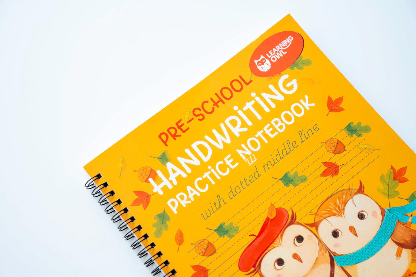 Learning Owl primary ruled workbook open flat showcasing thick pages with dotted midline spacing.
