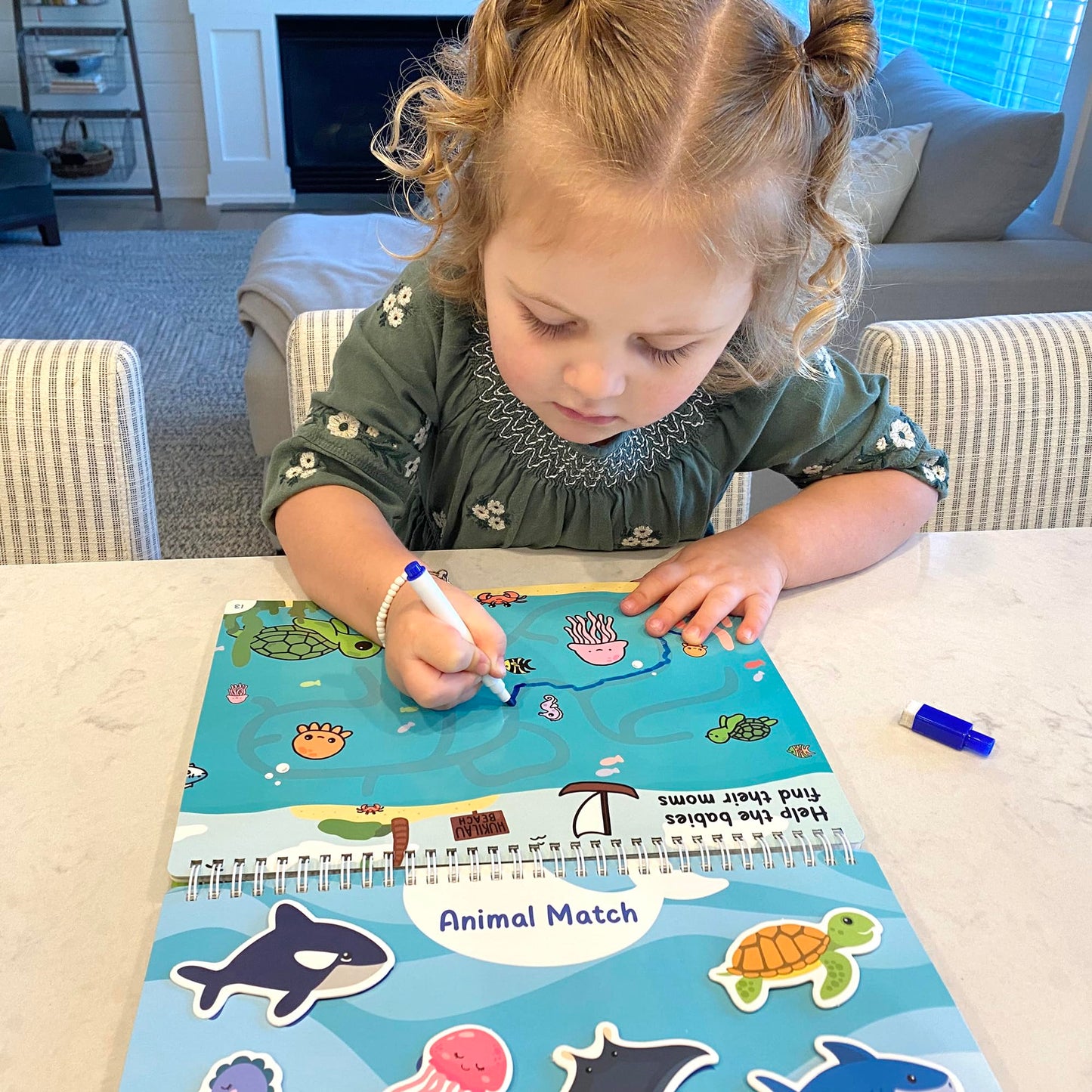 Sensory busy book open to the USA map and emotional awareness theme pages.