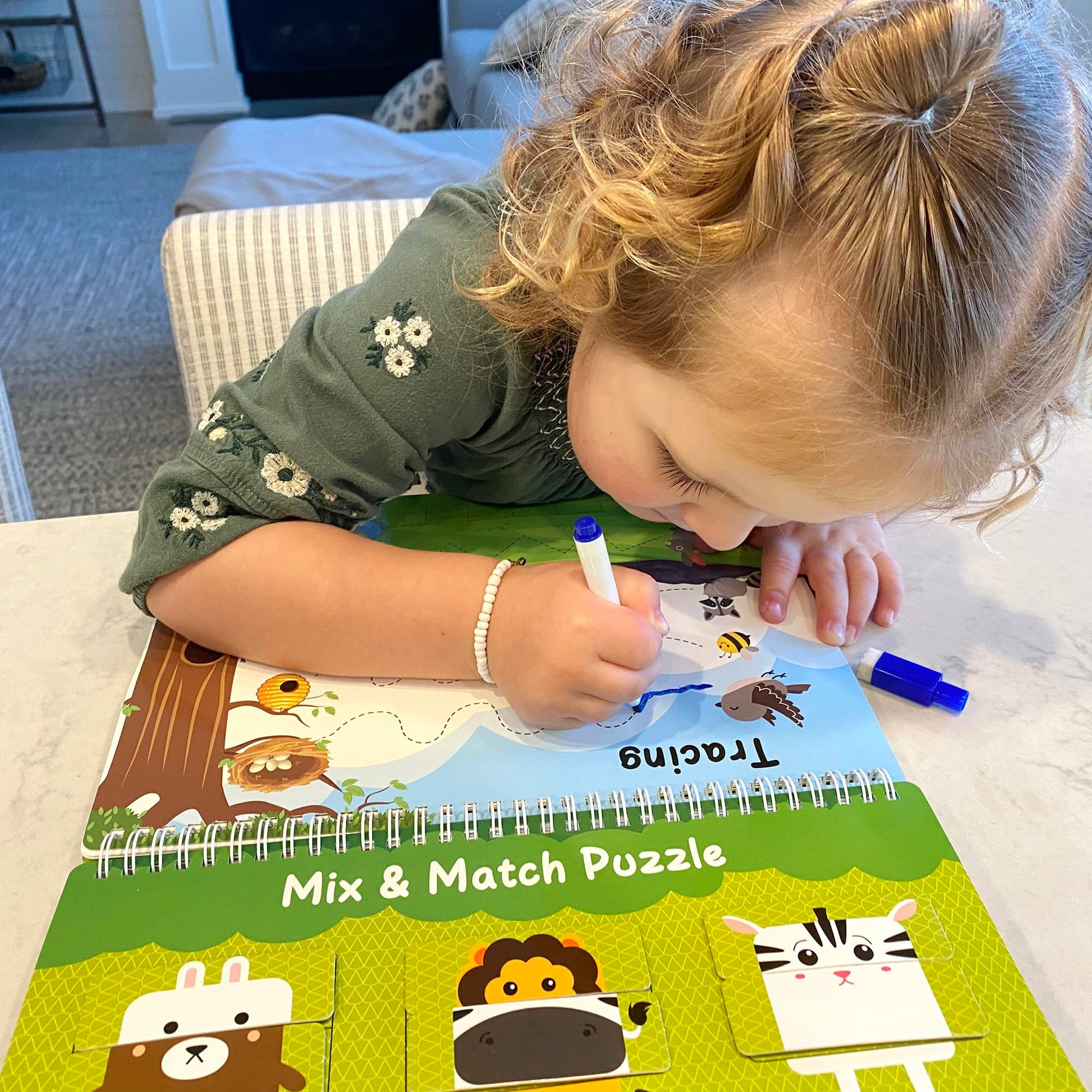 Toddler hands interacting with the premium pre assembled preschool workbook for fine motor practice.