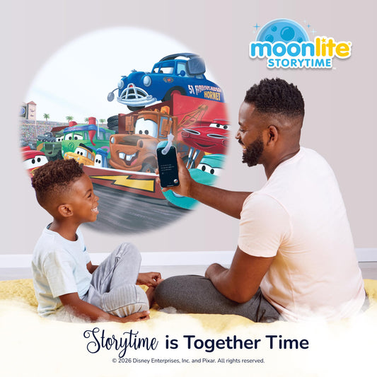 Moonlite smartphone projector accessory showing how the Cars picture disc slides into the slot.