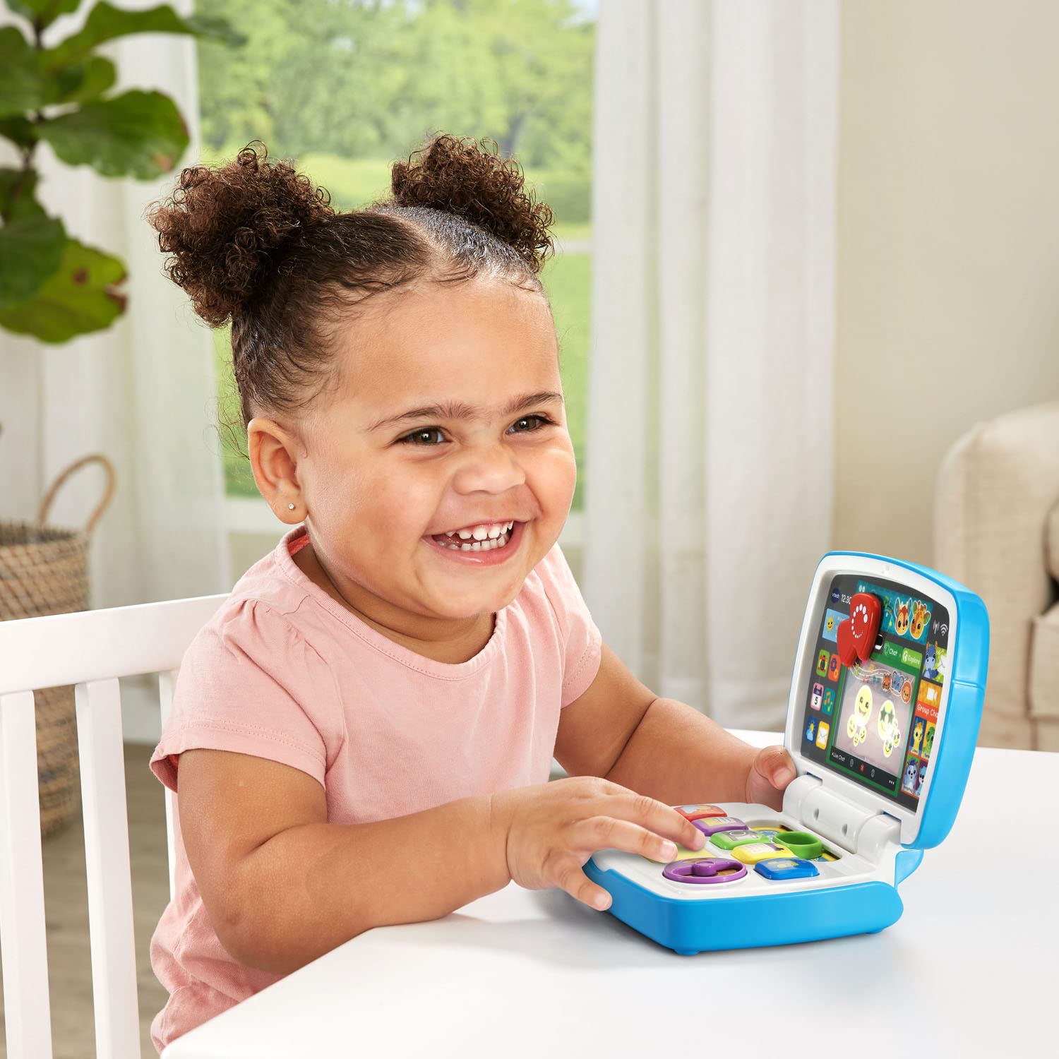 VTech electronic learning laptop highlighting the spinning disc and weather buttons for fine motor play.
