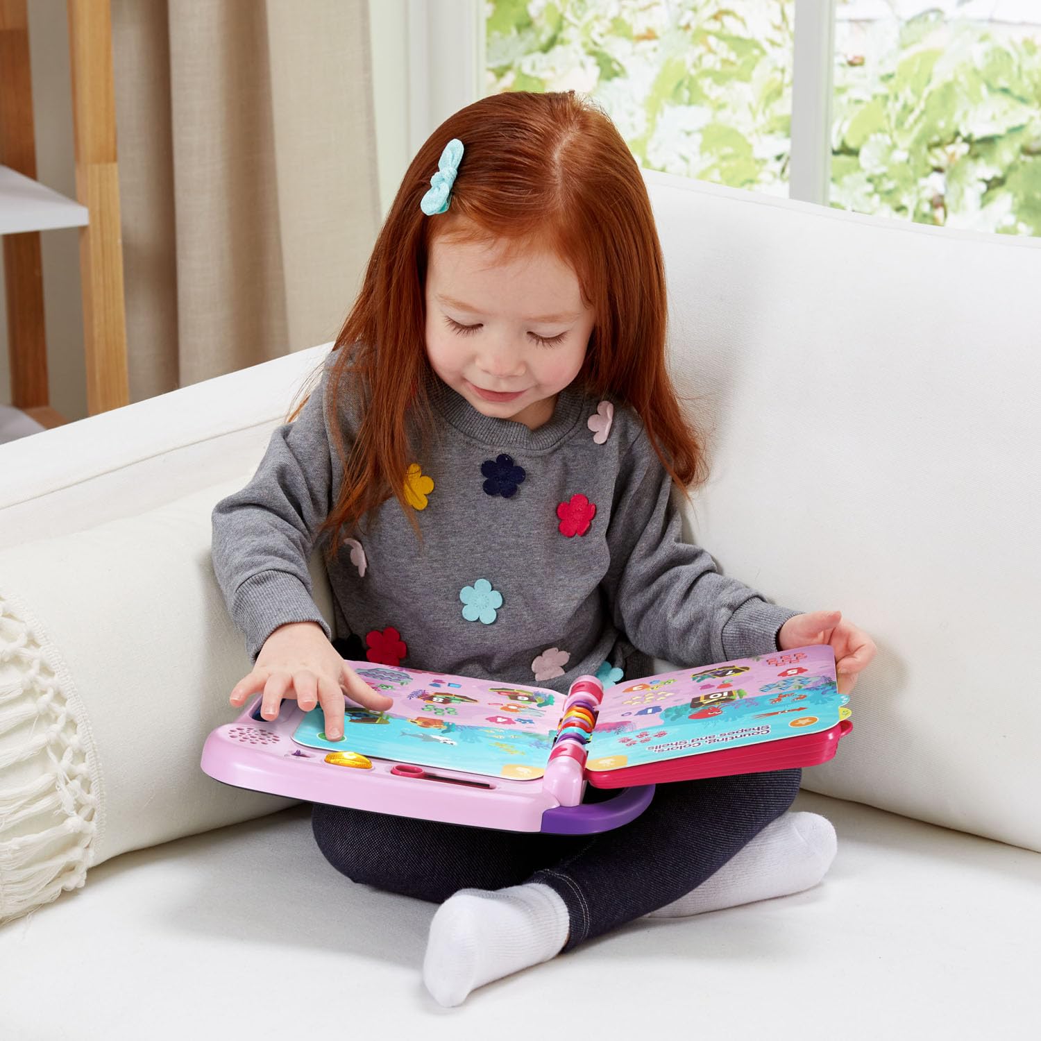 Side profile of durable LeapFrog electronic book demonstrating battery compartment and easy carry handle