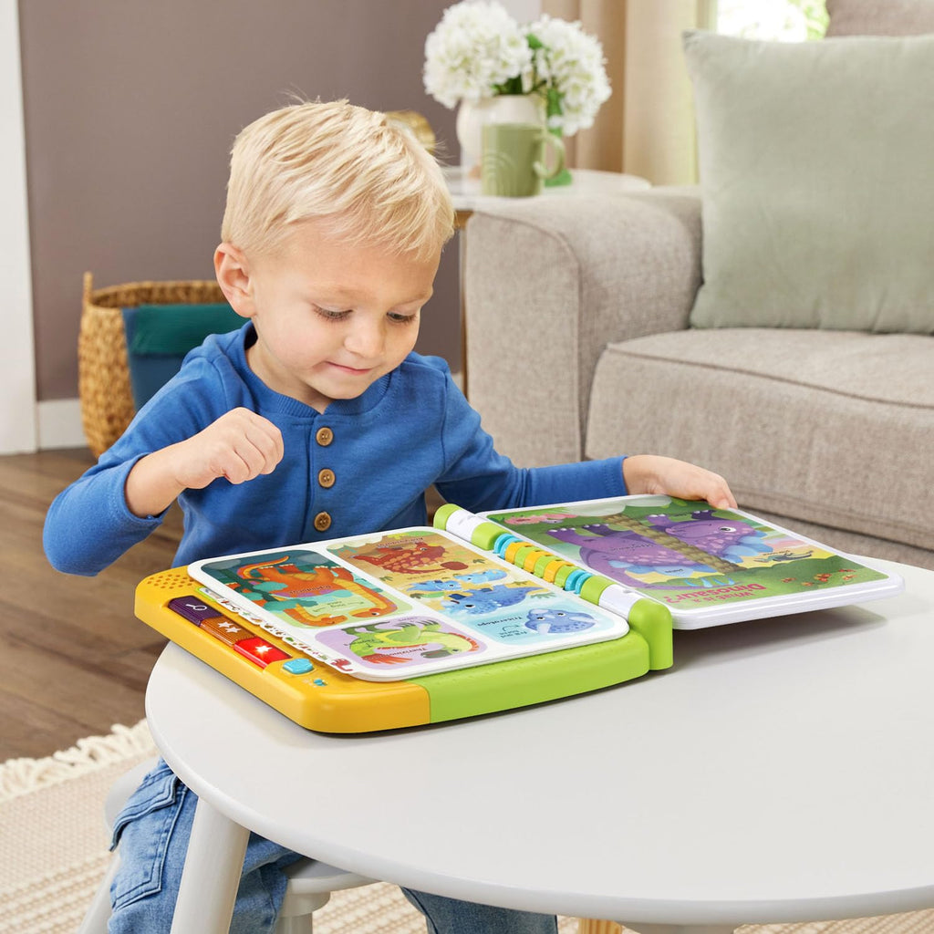 Toddler hands pressing the interactive touch points on the LeapFrog prehistoric book pages