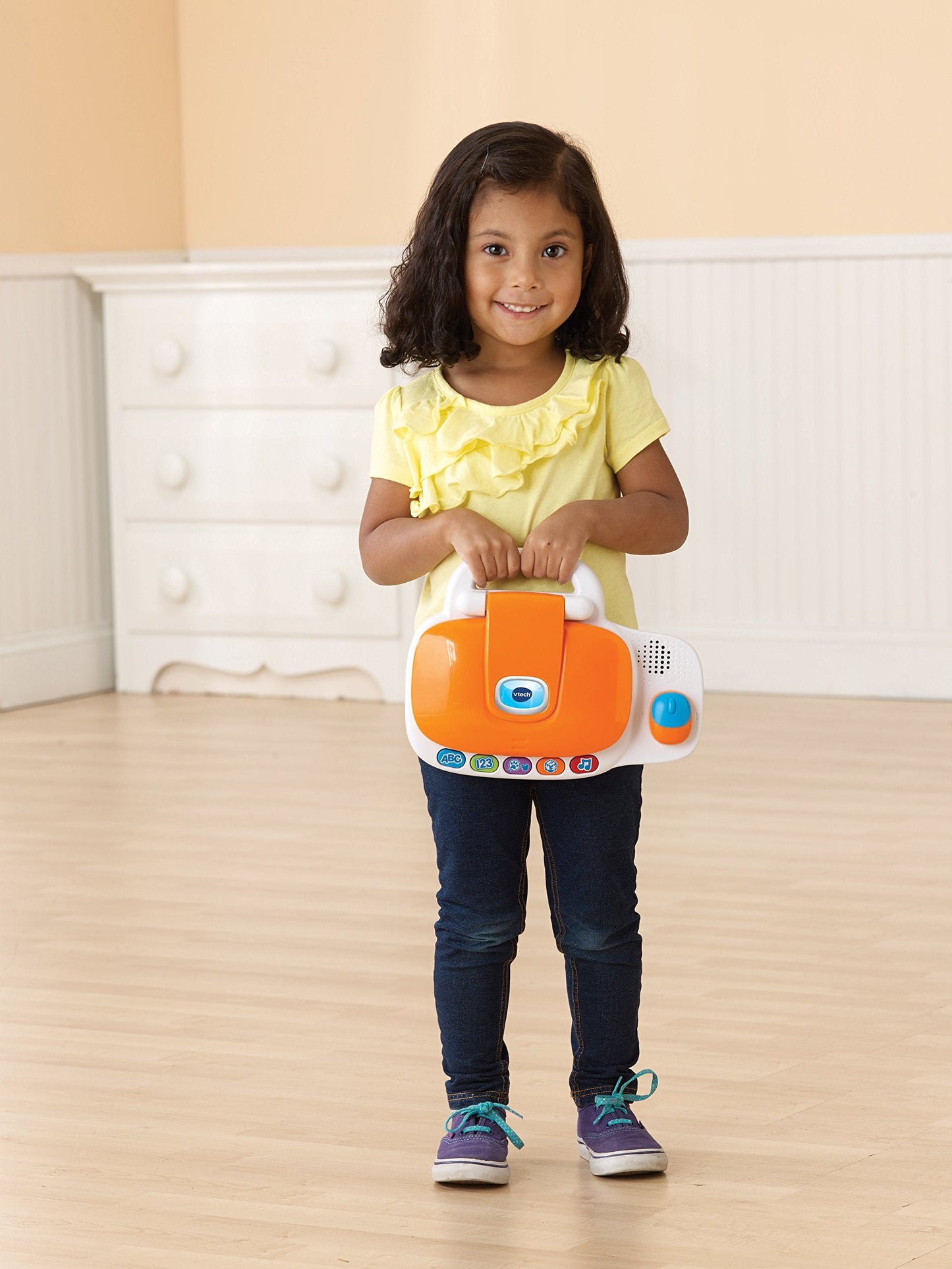 VTech interactive learning device highlighting the battery compartment and durable plastic construction.