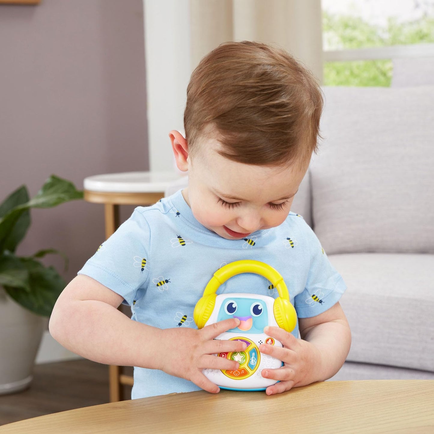 LeapFrog Sing-Along educational toy illuminating its screen face during a learning song playback.