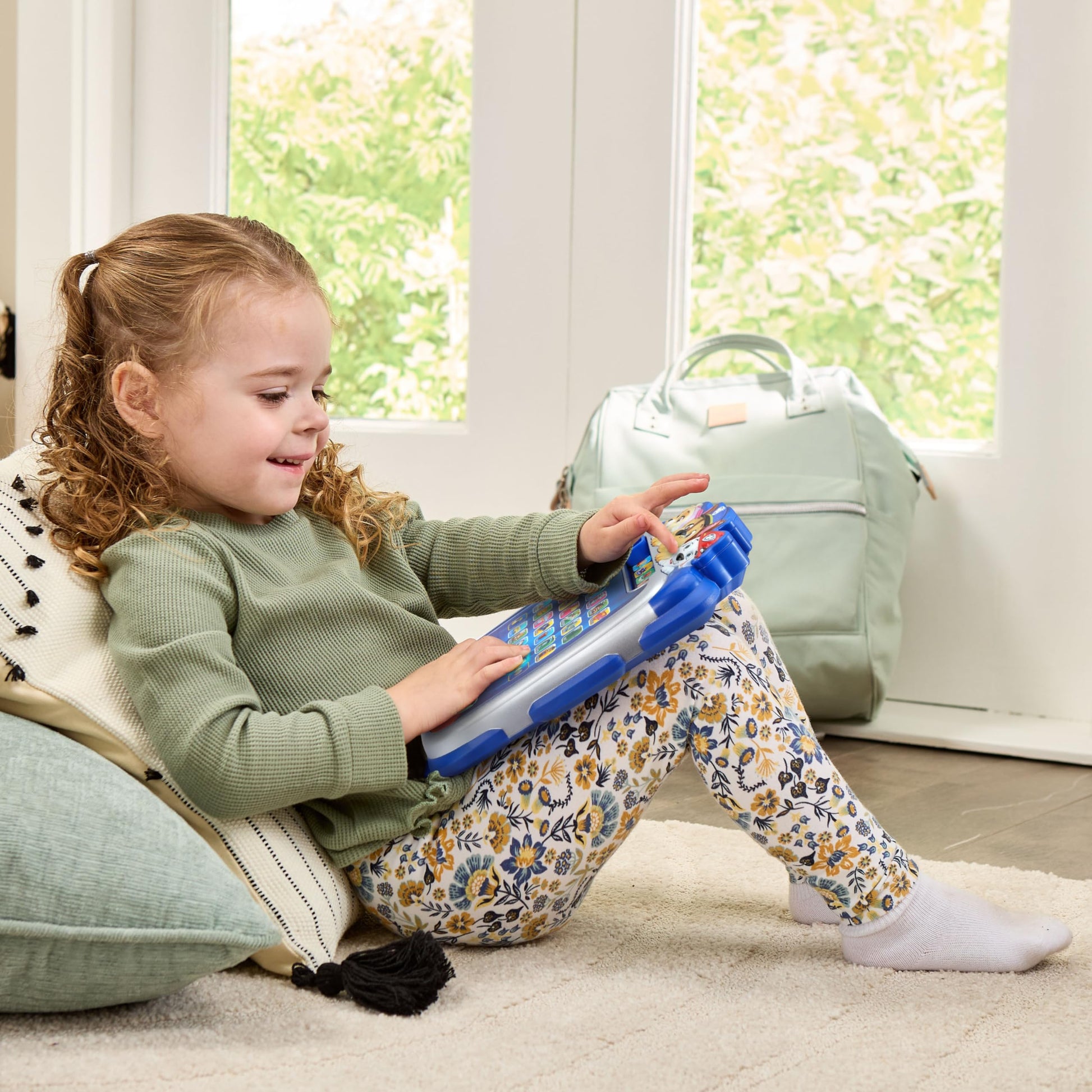 VTech alphabet learning console operating with illuminated letter keys during an interactive spelling mission.