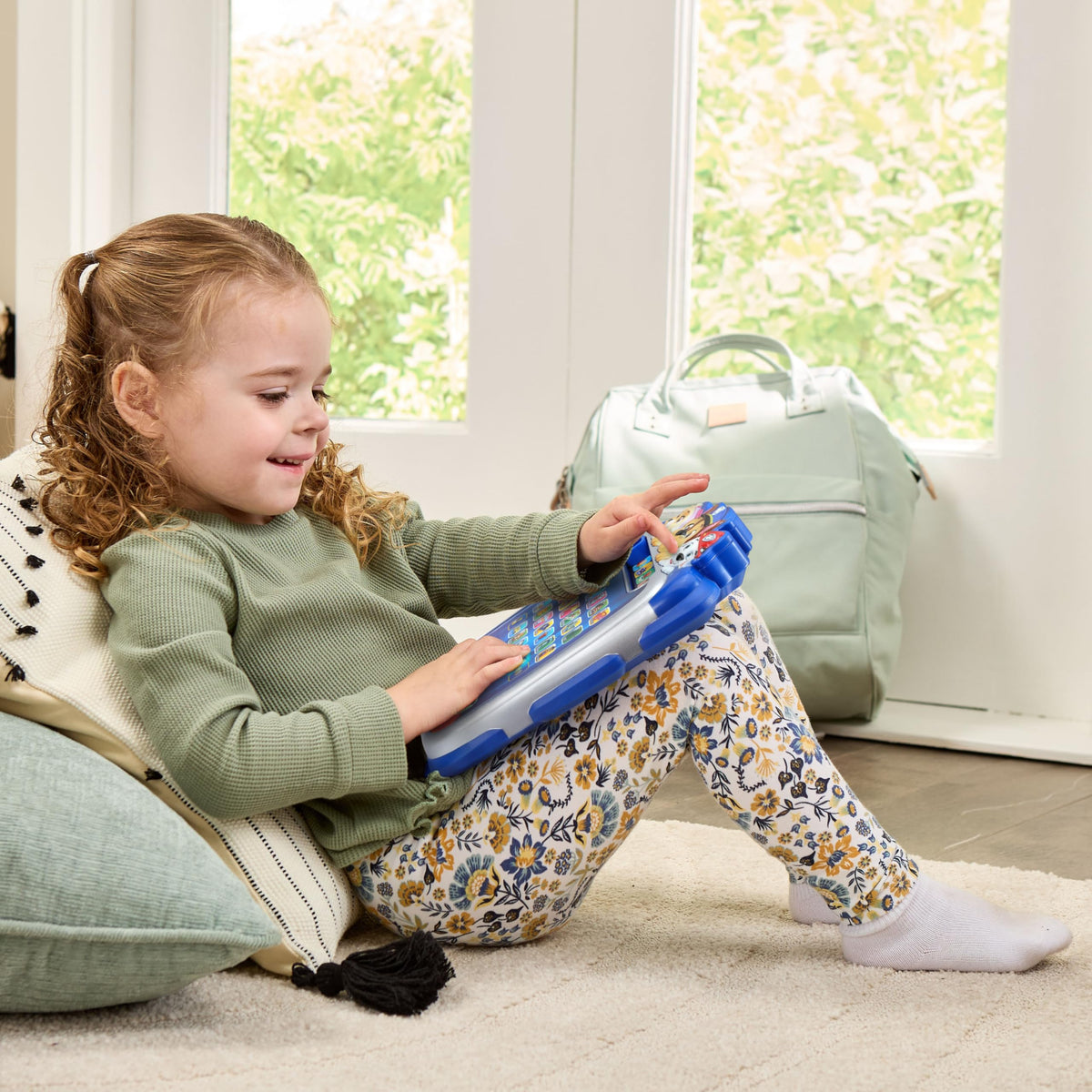 VTech alphabet learning console operating with illuminated letter keys during an interactive spelling mission.