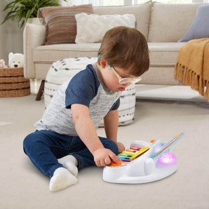 LeapFrog bilingual baby piano displaying the colorful light-up cloud face during operation.