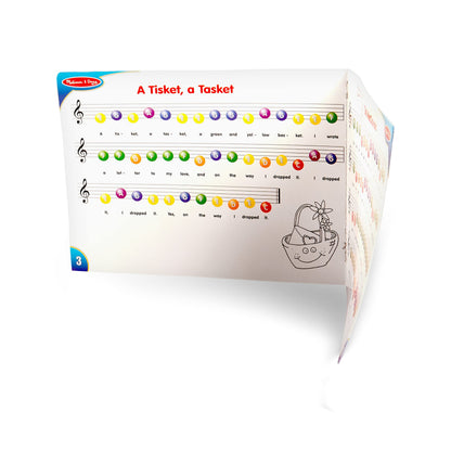 Melissa & Doug classic toy piano packaging showing the full multi color setup.