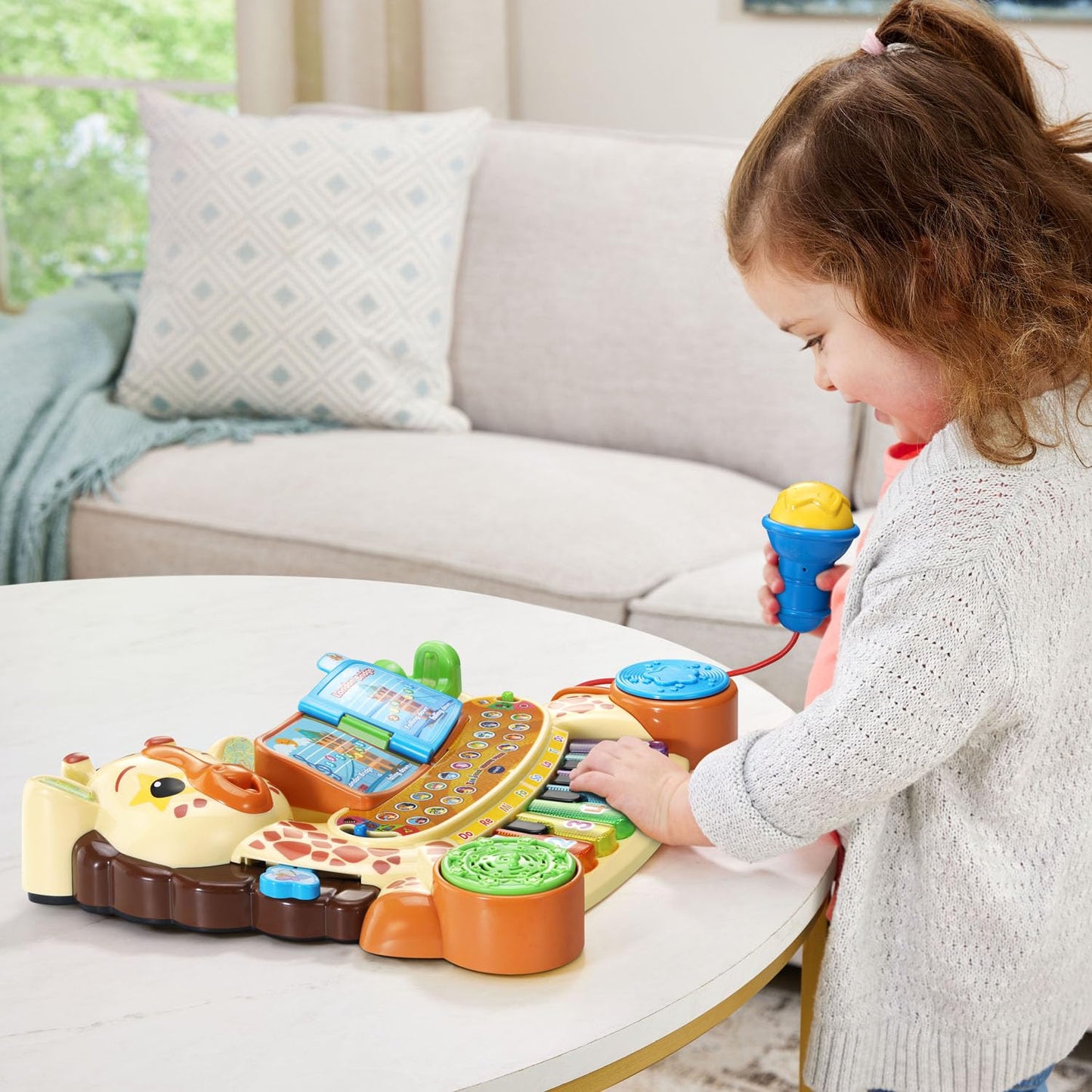 Multicolor giraffe musical toy displaying the four instrument selection buttons