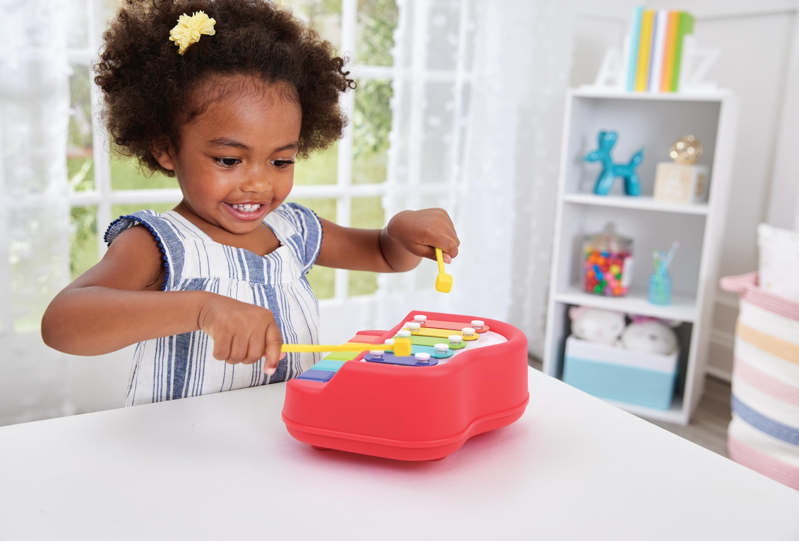 Kidoozie two-in-one toddler music toy being played with the included dual mallets.