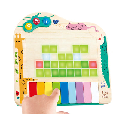 Hape wooden pixel piano toy showing glowing LED screen graphics