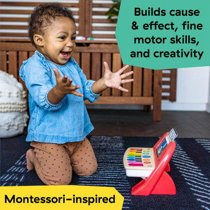 Baby Einstein interactive musical baby toy showing the buttonless wood touch-sensitive panel surface.