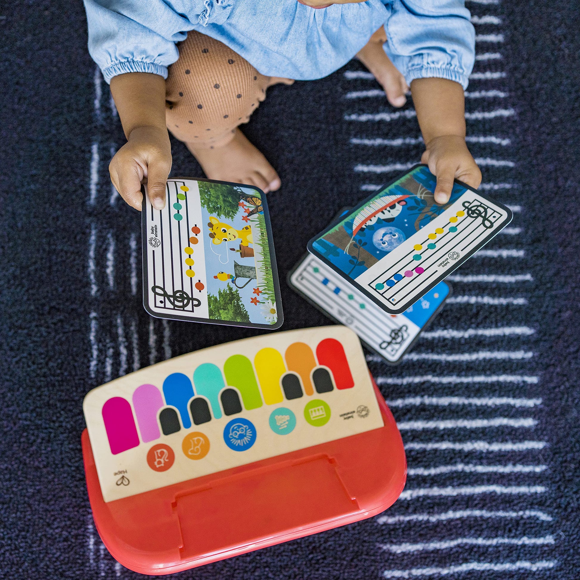 Complete set view of the Baby Einstein musical toy including the three double sided learning sheets.