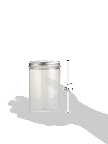 Child hands carefully sprinkling organic chia seeds over the potting soil inside the clear plastic craft jar.