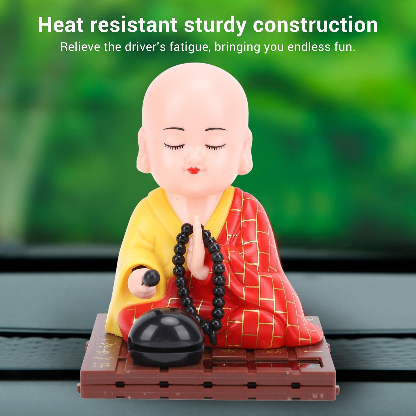 Tyenaza Red Monk Car Ornament displayed beautifully on a brightly lit office desk.