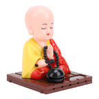 Tyenaza Little Monk Figurine placed near a window capturing natural sunlight for movement.