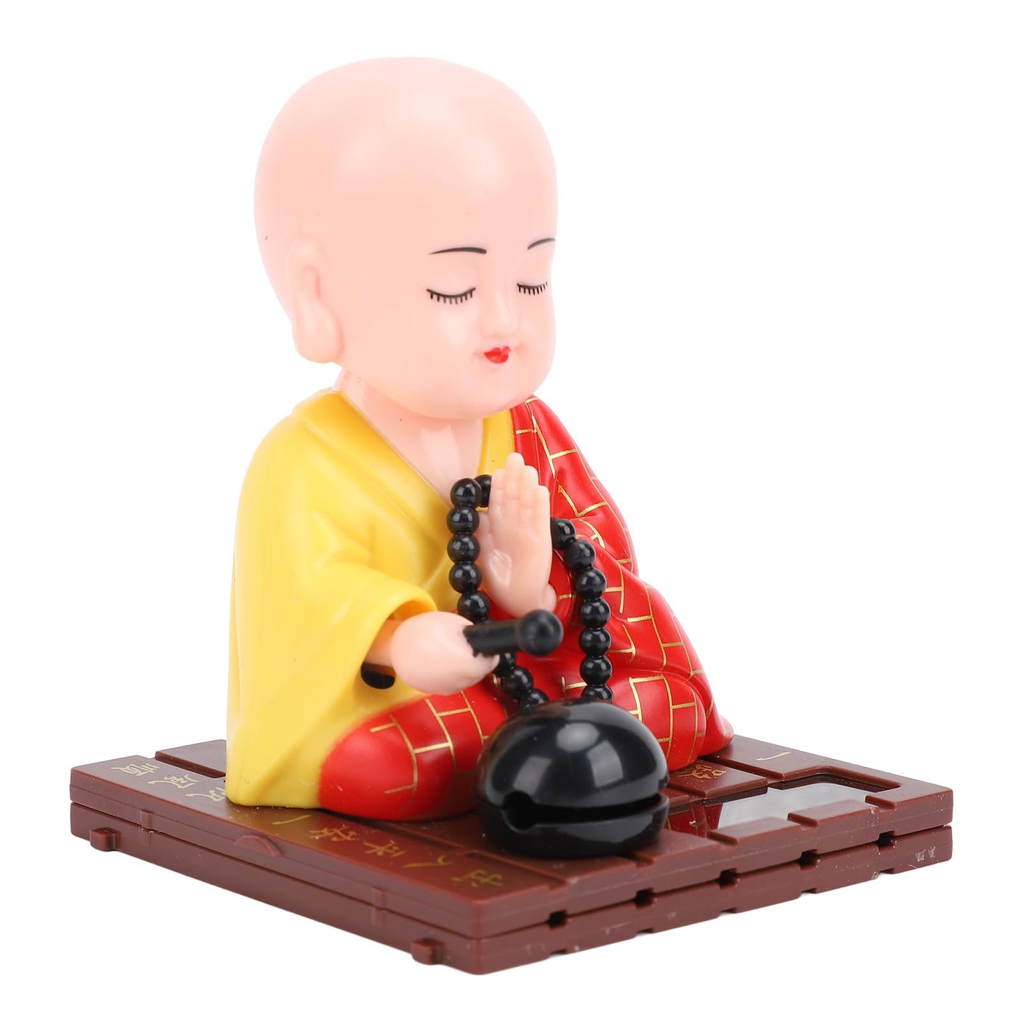 Tyenaza Little Monk Figurine placed near a window capturing natural sunlight for movement.