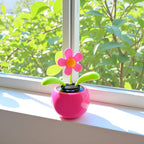 Charming pink floral bobblehead dancer dashboard decoration side view profile.